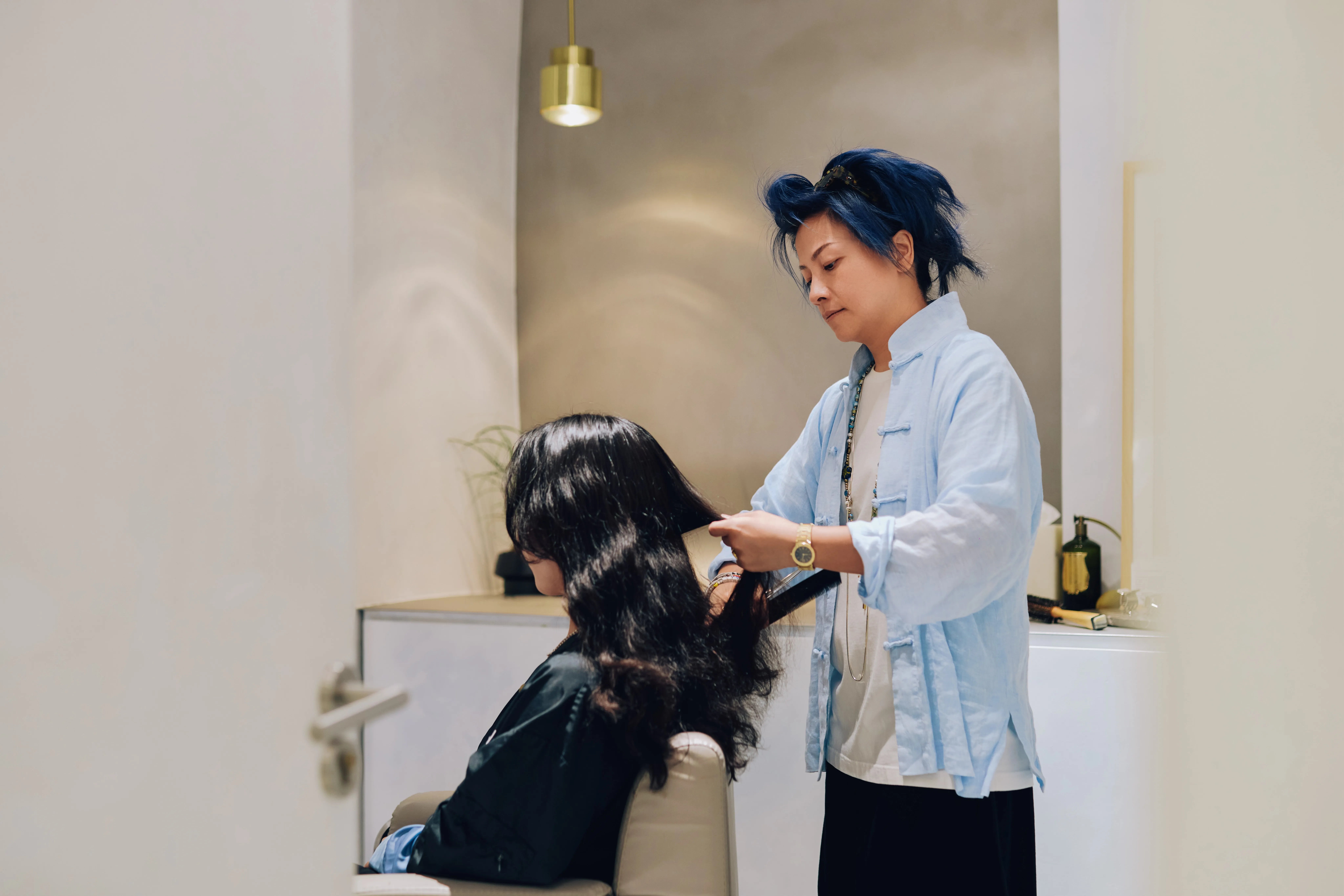 Marvin Lin styling a client's hair at SHHH salon