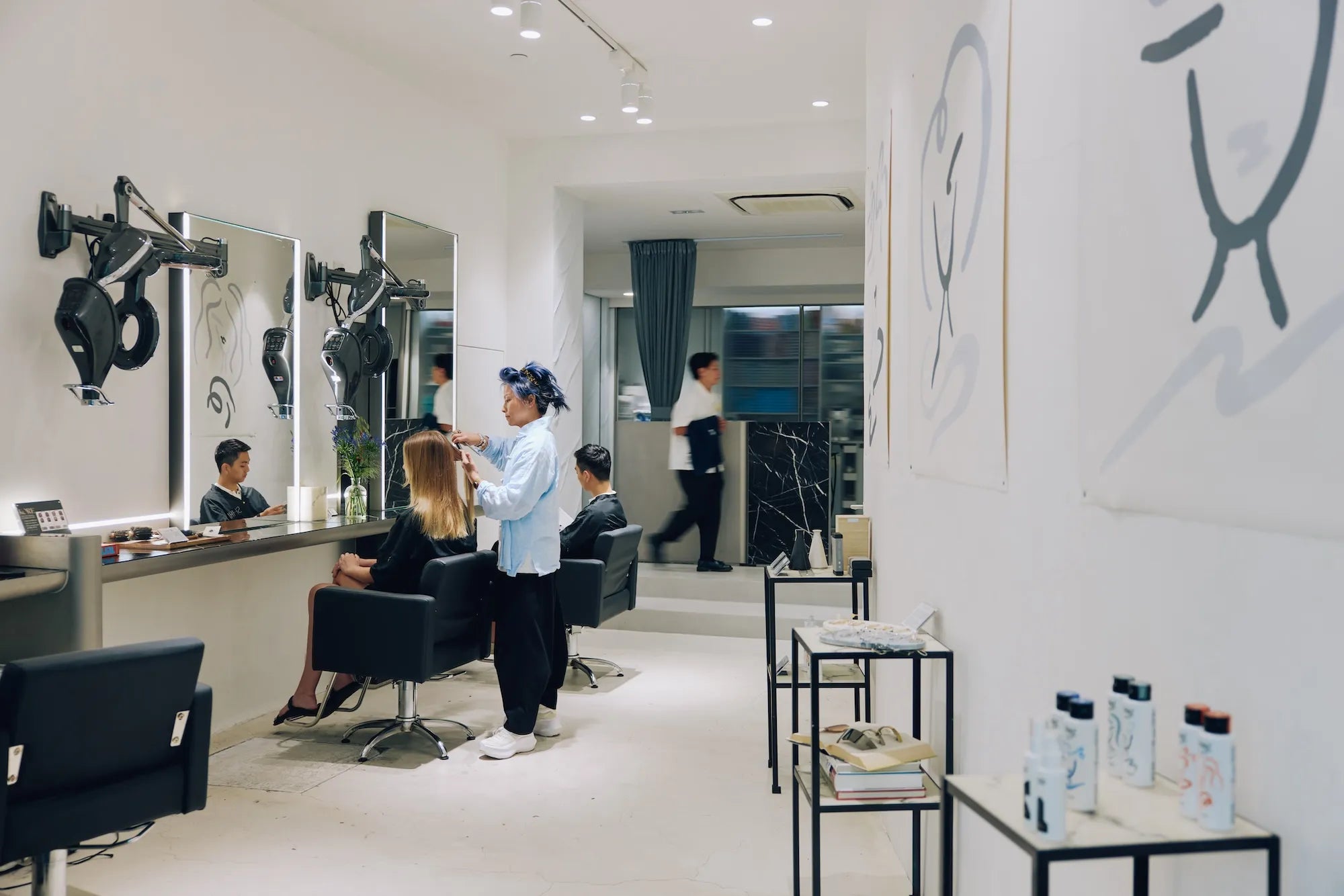 Stylist treating a client at SHHH salon in Central, Hong Kong